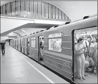  ?? AP/SERGEI CHUZAVKOV ?? Passengers board a subway train in Kiev, Ukraine, on June 28, a day after a cyberattac­k paralyzed many computer systems.