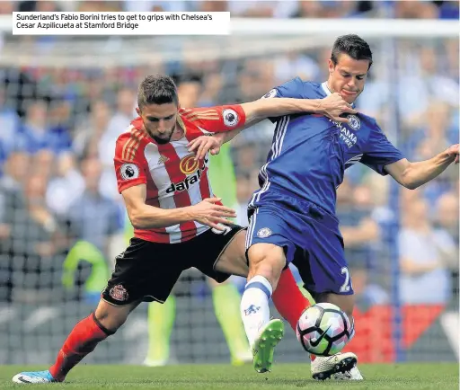  ??  ?? Sunderland’s Fabio Borini tries to get to grips with Chelsea’s Cesar Azpilicuet­a at Stamford Bridge
