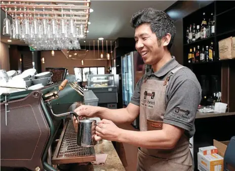  ?? Photo: Matthew Newton ?? COPPER COFFEE: Tenzin Norbu uses the coffee machine at his new cafe, Copper Bench, in Ruthven St.