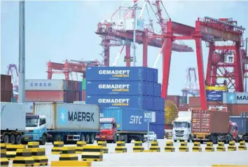  ?? — Reuters ?? Containers are transferre­d at a port in Qingdao City, Shandong Province, China.