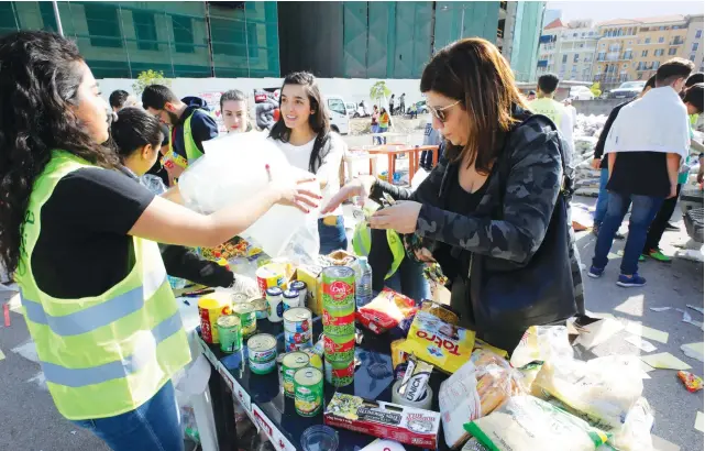  ?? AFP ?? Volunteers sort through aid in Beirut’s Martyrs Square to help needy Lebanese families amid an economic crisis that has plunged large numbers into poverty. But according to one philanthro­pist, ‘people are still there for each other.’
LEBANON