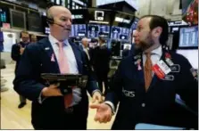  ?? RICHARD DREW — THE ASSOCIATED PRESS ?? Trader Patrick Casey, left, and specialist Michael Pistillo work on the floor of the New York Stock Exchange, Thursday.