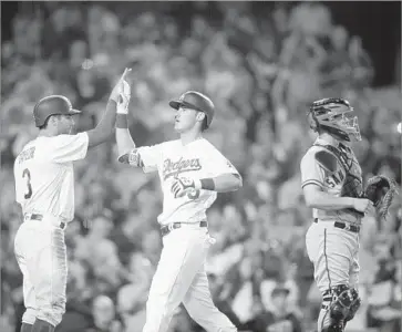  ?? Allen J. Schaben Los Angeles Times ?? CODY BELLINGER IS GREETED by Chris Taylor, left, at home plate after his three-run homer in the third inning against San Francisco starter Jeff Samardzija capped a four-run outburst.