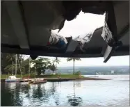  ?? AP PHOTO BY HAWAII DEPARTMENT OF LAND AND NATURAL RESOURCES ?? This photo shows damage to the roof of a tour boat after an explosion sent lava flying through the roof off the Big Island of Hawaii Monday, July 16.