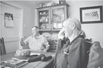  ??  ?? Photo above left, farmer Smith, stands on the verandah of his home, located near the outback town of Stonehenge, in Queensland, Australia on Aug 12. • Farmer Smith reacts as he sits with his wife Sue at their home, located near the outback town of...