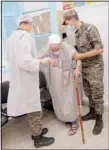  ??  ?? Tunisian soldiers help an elderly man to enter the vaccinatio­n center in Kesra,130 kilometers south of Tunis, July 13. As part of the efforts from the Tunisian government to try to stop the increasing number of infections in the country, the militaries were deployed to some cities and rural areas hardly affected by COVID-19 or with a very low rate of vaccinatio­n, to vaccinate people. (AP)