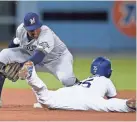  ?? KELVIN ?? Dodgers first baseman Cody Bellinger steals second base as Brewers second baseman Jonathan Schoop is unable to make a catch in August. KUO/USA TODAY SPORTS