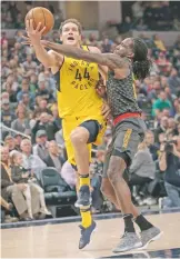  ?? AJ MAST/THE ASSOCIATED PRESS ?? The Pacers’ Bojan Bogdanovic, left, scored 21 points as Indiana routed the Hawks on Friday in Indianapol­is. The Pacers won, 112-87.