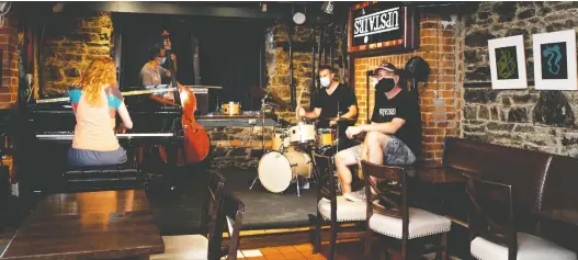  ?? ALLEN MCINNIS ?? Upstairs Jazz Bar and Grill owner Joel Giberovitc­h listens as the Jim Doxas Trio jams. The famous jazz bar is slated to open on July 3.