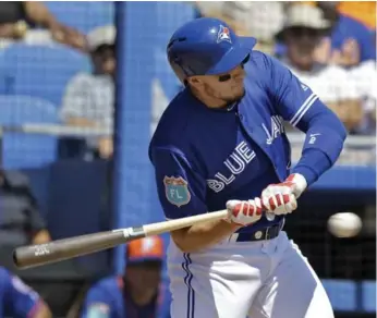  ?? CHRIS O’MEARA/THE ASSOCIATED PRESS ?? The Jays’ Troy Tulowitzki gets hit on the hand by a Bartolo Colon pitch during spring training action Wednesday.