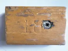  ?? Tori Ritchie ?? A piece of a onetime Memorial Stadium seat includes a number and bolt hole. Wood salvaged from the stadium renovation is being sold by a firm that is going out of business.