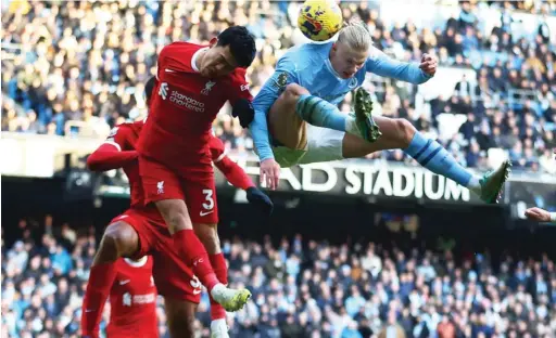  ?? ?? Liverpool’s Wataru Endo emsured he was not outjumped by Man City’s Erling Haaland when both sides met in the reverse fixture at the Etihad Stadium