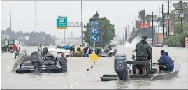  ?? PRESS] [DAVID J. PHILLIP/THE ASSOCIATED ?? Volunteer rescue boats make their way into a flooded subdivisio­n to rescue stranded residents Monday in Spring, Texas.