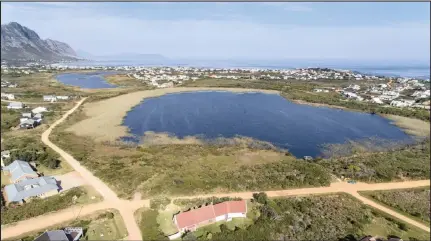  ??  ?? Aerial view of Betty’s Bay’s two lakes known as Klein Klei and Groot Wit Klei with distant sea views.