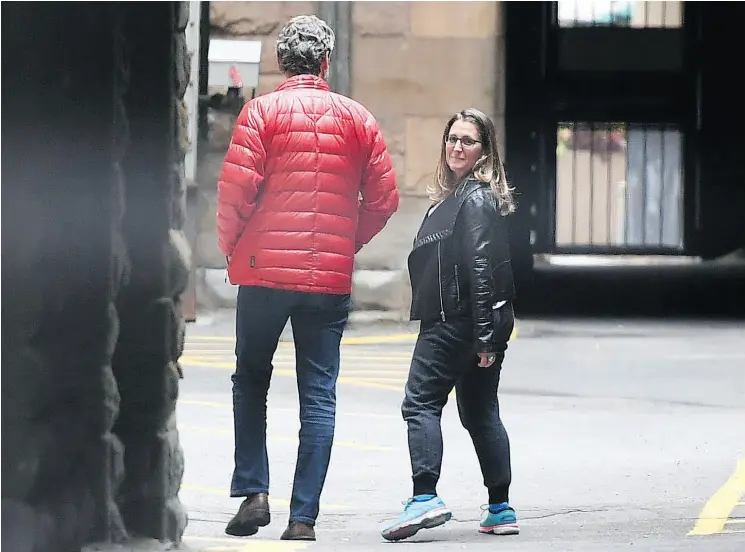  ?? JUSTIN TANG / THE CANADIAN PRESS ?? Minister of Foreign Affairs Chrystia Freeland and Gerald Butts, senior political adviser, walk in the loading dock of the Office of the Prime Minister and Privy Council on Sunday.