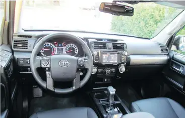  ??  ?? The 2018 Toyota 4Runner interior has a decidedly retro look, apart from the touchscree­n.