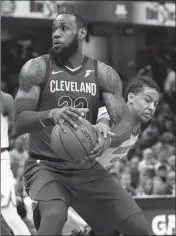  ?? ASSOCIATED PRESS ?? CLEVELAND CAVALIERS’ LEBRON JAMES, left, drives past New York Knicks’ Trey Burke in the first half of an NBA basketball game, Wednesday in Cleveland.