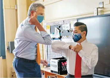  ??  ?? Mayor de Blasio elbow-bumps Carranza at Brooklyn’s New Bridges Elementary School on August 19, 2020.