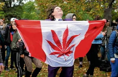  ?? —REUTERS ?? CANADA GETS HIGH Aman dances with a marijuana flag at Trinity Bellwoods Park in Toronto, Ontario, on Wednesday, celebratin­g Canada’s legalizati­on of recreation­al marijuana. Canada became the second country to legalize pot after Uruguay did it in 2013.