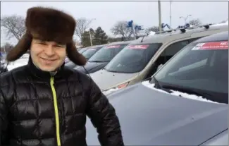  ?? MICHAEL HILL — THE ASSOCIATED PRESS ?? Michael’s Auto Plaza general manager Eugene Rubinchuk stands in the lot of his family’s business in East Greenbush, N.Y. The car dealership accepts bitcoin and several other digital currencies.