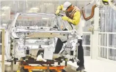  ??  ?? A Volkswagen employee performs a chisel check to analyze the strength of welds on the chassis of a Volkswagen Passat at the Chattanoog­a manufactur­ing plant.