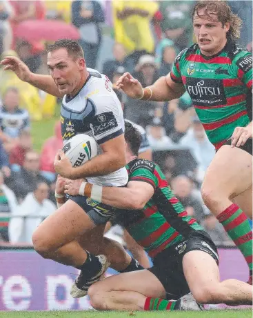  ?? Picture: AAP ?? HIGH PROFILE: Scott Bolton of the Cowboys is tackled by Angus Crichton and George Burgess (right) of the Rabbitohs at Barlow Park in July.
