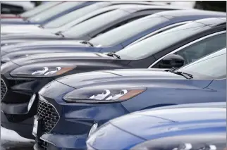  ?? DAVID ZALUBOWSKI — THE ASSOCIATED PRESS ?? For much of the past three years, car prices knew one direction — upward. But prices are expected to decline this year as chips and other components become more readily available.