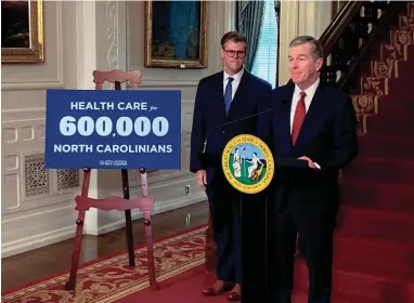  ?? GARY D. ROBERTSON/AP ?? Kody Kinsley, left, listens while Gov. Roy Cooper speaks at a September news conference in Raleigh.