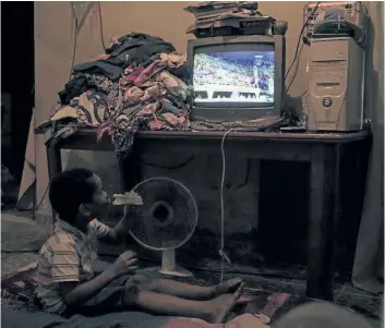  ?? FELIPE DANA/ASSOCIATED PRESS ?? Paulo Cesar watches the 2016 Summer Olympics gymnastics competitio­n live on a television as he sits inside his house at a slum in Rio de Janeiro, Brazil, Tuesday, Aug. 9.