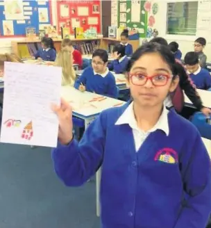  ??  ?? ●●A Belfield Primary School pupil with a Christmas letter