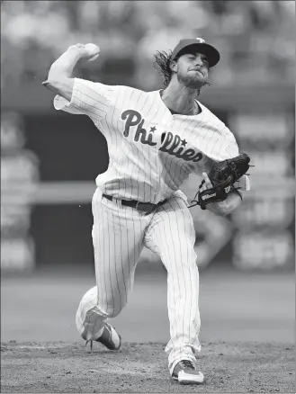  ?? MICHAEL PEREZ/AP PHOTO ?? Phillies starting pitcher Aaron Nola throws during the first inning of Friday’s game against the Mets at Philadelph­ia. Nola earned the victory as the Phillies won 4-2.