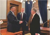  ?? KATIE BERNARD The Kansas City Star ?? Kansas Attorney General Kris Kobach (left) speaks with Kansas Bureau of Investigat­ion executive officer Bob Stuart (middle) and Sen. Mike Thompson (right) ahead of a press conference.