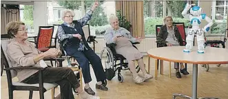  ?? REGY VAN DEN BRAND/ WASHINGTON POST ?? Residents at Dutch retirement home Vughterste­de follow Zora the robot’s instructio­ns during a physical therapy class. The Zora robot is also being used in hospitals.