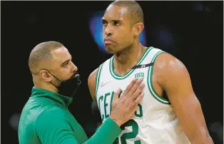  ?? MATT STONE/BOSTON HERALD ?? Celtics coach Ime Udoka comforts Al Horford during the second half of Game 6 in Boston on Thursday. Horford’s $26.5 million deal for next season is just partially guaranteed, but even at age 36, locking it in will be a formality.