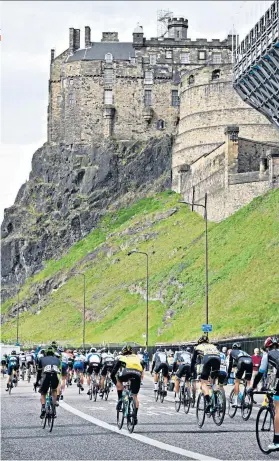  ??  ?? Spectacula­r setting: The Tour of Britain riders make their way past Edinburgh Castle yesterday