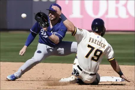  ?? MORRY GASH — THE ASSOCIATED PRESS ?? Los Angeles Dodgers’ Gavin Lux tags out Milwaukee Brewers’ Sal Frelick at second on a stolen base attempt during the second inning of a spring training baseball game Saturday, Feb. 25, 2023, in Phoenix.