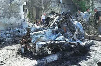  ?? REUTERS ?? People inspect the site of a car bomb blast in Damascus, Syria, on Sunday.