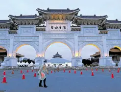  ?? —PHOTOS BY REUTERS ?? VENUE WITH A VIEW A medical worker walks past a newly set up COVID-19 test drive-through site at Liberty Square in Taipei, Taiwan, on May 17.