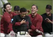  ?? TONY AVELAR — THE ASSOCIATED PRESS ?? Stanford's Drew Bowser, center, is mobbed by teammates after his game-winning hit against Texas on Monday.