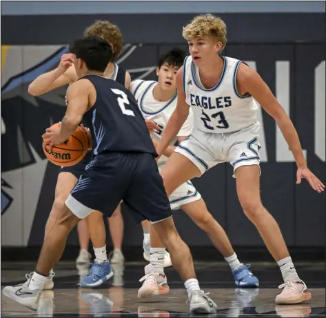  ?? AARON ONTIVEROZ — THE DENVER POST ?? Valor Christian’s Brady Wynja (23) defends Ralston Valley’s Jackson Hansen (2) in Highlands Ranch on Jan. 10. during the first half of a game at Valor