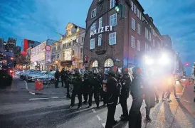  ??  ?? Police stand outside the Davidswach­e police station during a protest against the G-20 summit Thursday in Hamburg, northern Germany.