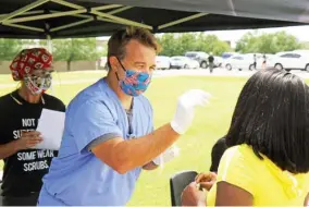  ??  ?? Dr. Cameron Huxford, a pulmonary critical care physician, administer­s a COVID-19 test to a student at East Mississipp­i Community College’s Scooba campus on Thursday. Huxford and OCH Regional Medical Center in Starkville are providing COVID-19 testing to EMCC students as part of a community outreach effort. (Submitted photo)