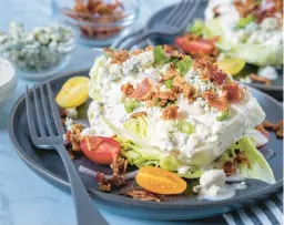  ?? DREAMSTIME ?? This classic wedge salad is embellishe­d with pancetta and cherry tomatoes.