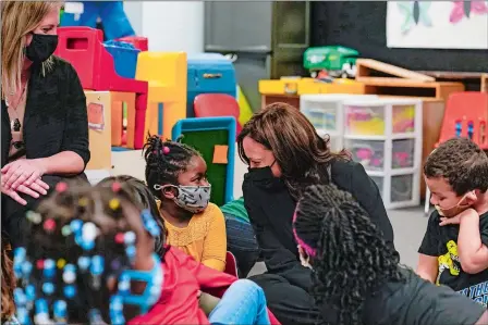  ?? SUSAN WALSH/AP PHOTO ?? Teacher Kathleen Malone, left, looks on as Vice President Kamala Harris visits with children Friday in a classroom at West Haven Child Developmen­t Center in West Haven.