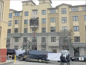  ??  ?? TRAGEDY: Police and officials at the apartment complex where a fourth floor balcony fell on to the one below it.