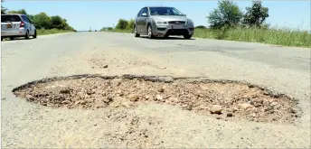  ??  ?? A motorist dodges a huge pothole in the middle of Nketa Drive in Nketa, Bulawayo on Friday. Potholes on the city roads which have been worsened by the rains are adding to motorists’ woes. (Picture by Eliah Saushoma)