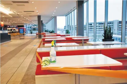  ?? TIM KROCHAK • THE CHRONICLE HERALD ?? A cleaner's spray bottle and wipe is seen on one of the taped-off tables in the food court at Scotia Square in Halifax on Tuesday.