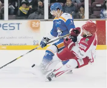  ??  ?? Cory McEwen is tripped by former Phantoms player Edgars Bebris of Swindon.