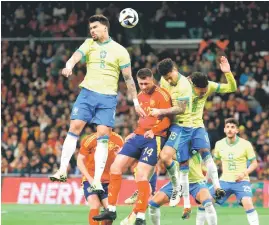  ?? — AFP photo ?? Brazil’s Paqueta (left) vies for a header with Spain’s Aymeric Laporte (centre) and Brazil’s Joao Gomes during the internatio­nal friendly match.
