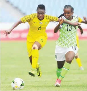  ??  ?? Super Falcons player, Ngozi Okobi (R) vies for the ball with South Africa’s Mamello Makhabane during the opening match of group B at the 2019 AWCON in cape Coast, Ghana